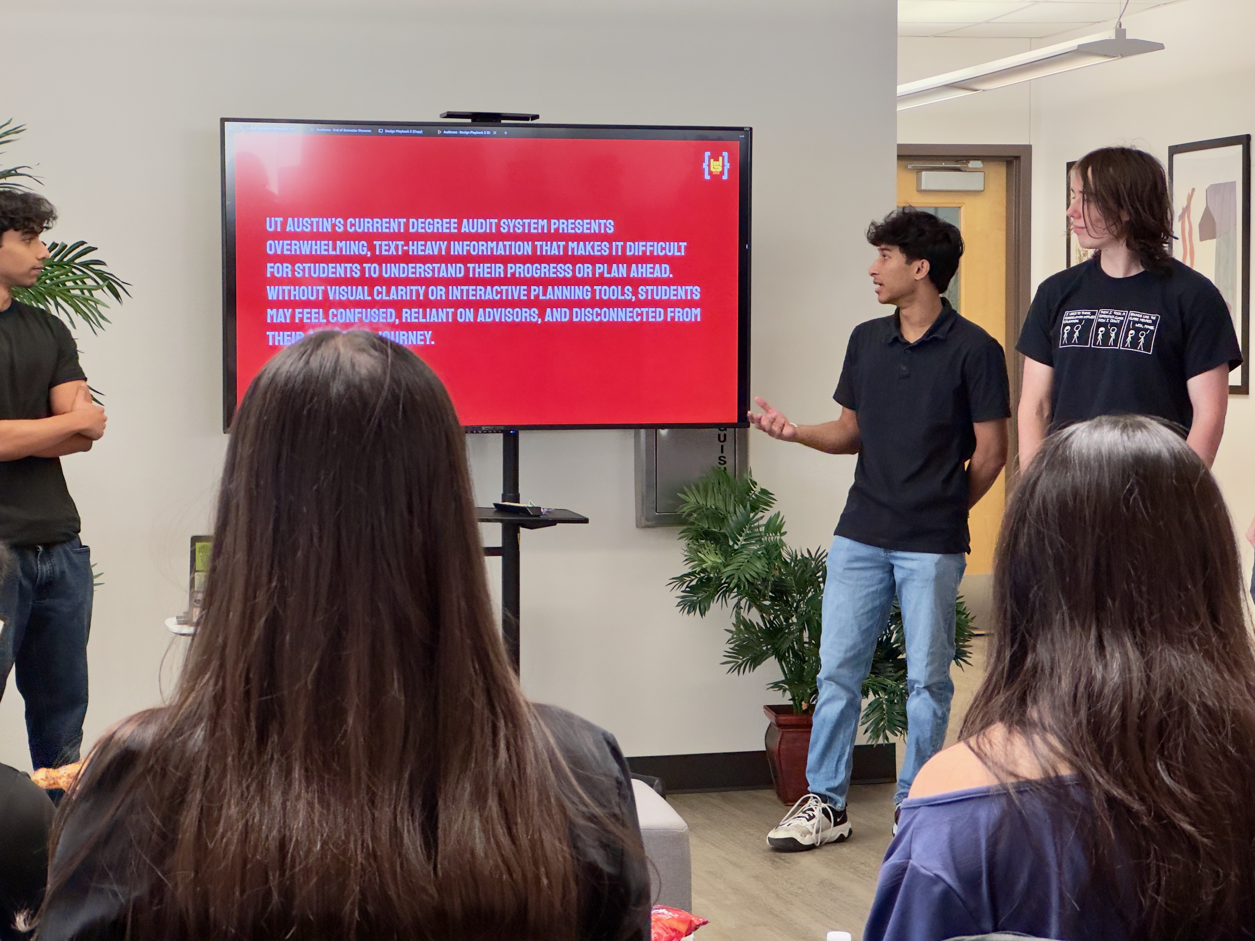 Students presenting work in a collaborative classroom setting at UT Austin